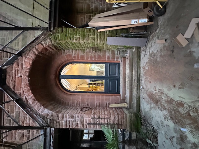Custom arched doorway in brick restoration project
