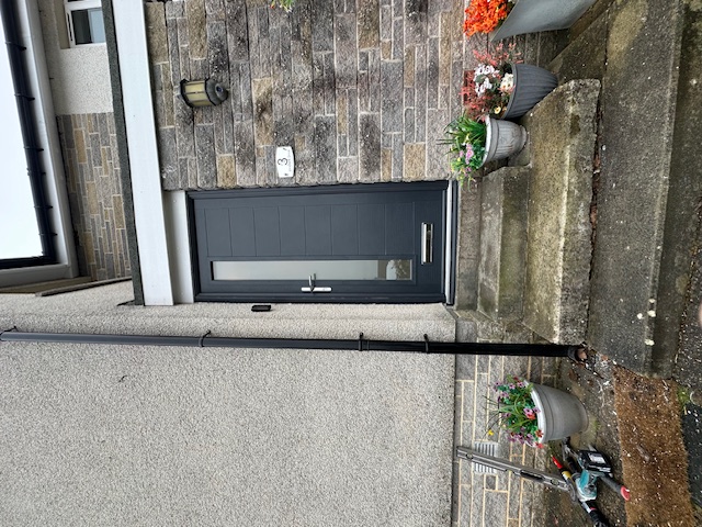 Contemporary gray composite front door with modern hardware